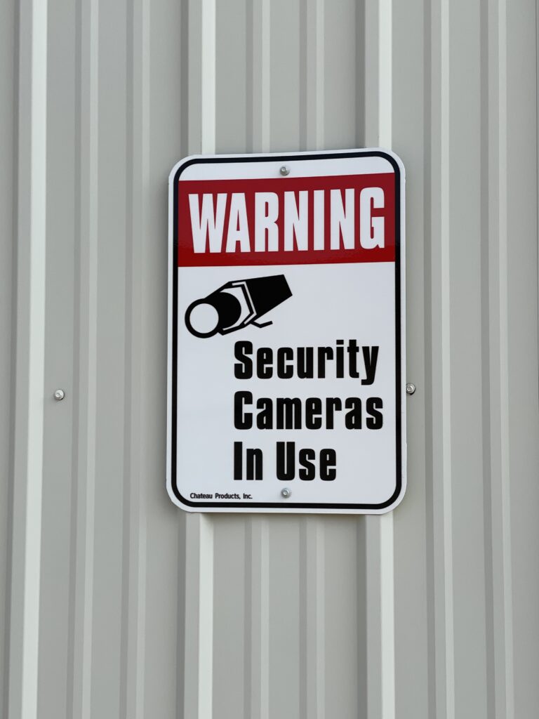 Warning Security Cameras In Use Sign at Davenport Storage Center in Davenport, Iowa